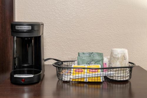 a coffee maker and a basket on a table at Red Roof Inn Norfolk - Portsmouth in Portsmouth