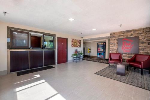 a lobby of a hotel with red chairs and a bar at Red Roof Inn Norfolk - Portsmouth in Portsmouth