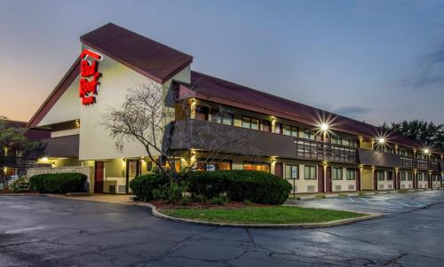 a hotel with a sign on the side of a building at Red Roof Inn Detroit - Plymouth/Canton in Plymouth