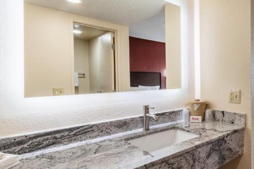a bathroom with a sink and a large mirror at Red Roof Inn El Paso West in El Paso