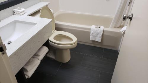 La salle de bains est pourvue de toilettes, d'un lavabo et d'une baignoire. dans l'établissement Red Roof Inn Port Allen, à Port Allen