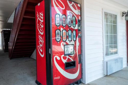 a coca cola vending machine next to a building at Red Roof Inn & Suites Wilson in Wilson