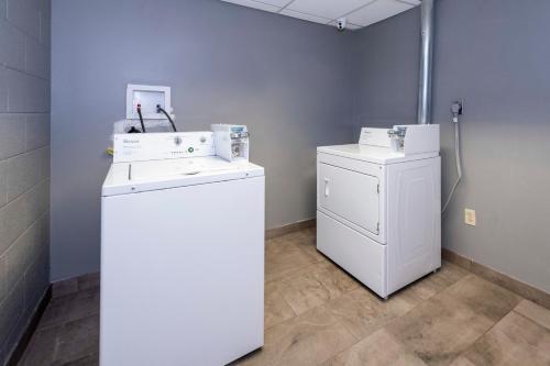 a laundry room with a washer and a dryer at HomeTowne Studios by Red Roof Wilmington - New Castle in New Castle