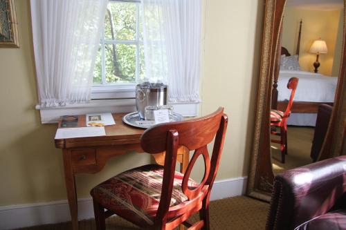 a desk in a room with a window and a mirror at Morris House Hotel in Philadelphia