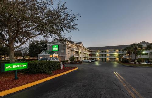 an empty parking lot in front of a hotel at HomeTowne Studios by Red Roof Orlando South in Orlando