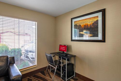 a room with a desk with a laptop and a window at Red Roof Inn San Marcos in San Marcos