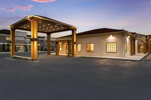 a building with a parking lot in front of it at Red Roof Inn Houston – Spring North in Spring