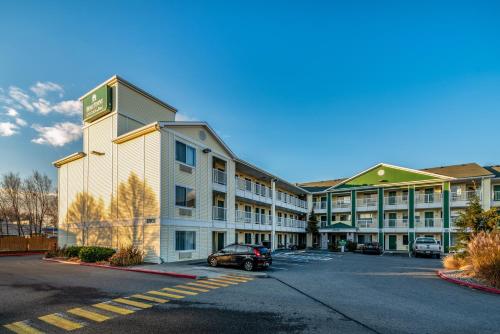 an empty parking lot in front of a hotel at HomeTowne Studios by Red Roof Spokane - Valley in Spokane Valley