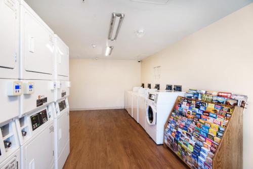 a laundry room with a washer and dryer at HomeTowne Studios by Red Roof Colorado Springs - Airport in Colorado Springs