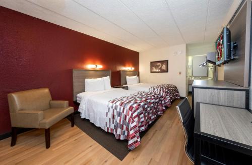 A bed or beds in a room at Red Roof Inn Tinton Falls-Jersey Shore