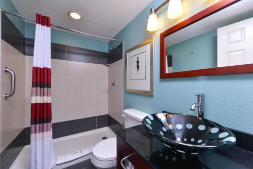 a bathroom with a sink and a toilet and a tub at Red Roof Inn Chambersburg in Chambersburg