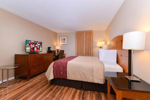 a hotel room with a bed and a desk at Red Roof Inn Chambersburg in Chambersburg