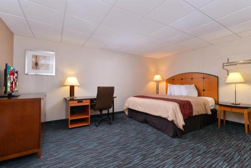 a hotel room with a bed and a desk at Red Roof Inn Chambersburg in Chambersburg