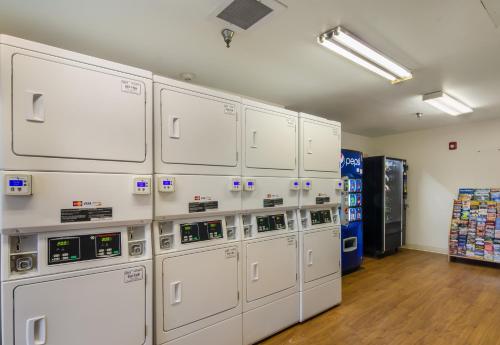 a row of white machines in a room at HomeTowne Studios by Red Roof Denver - Glendale/ Cherry Creek in Denver