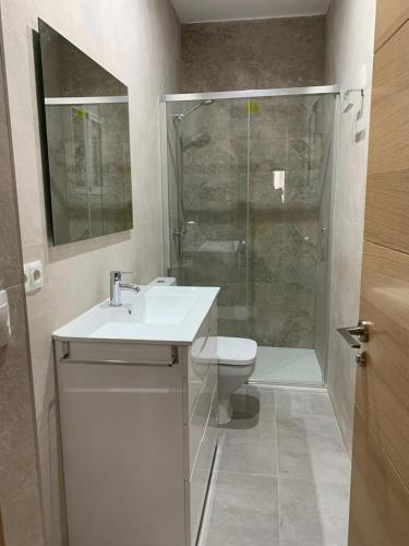 a bathroom with a toilet and a sink and a shower at UIM Mediterraneo PB Aragon A Wifi in Puerto de Sagunto
