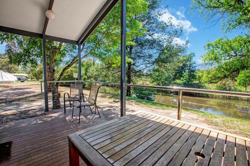 a porch with a table and a chair on a deck at BIG4 Taggerty Holiday Park in Taggerty