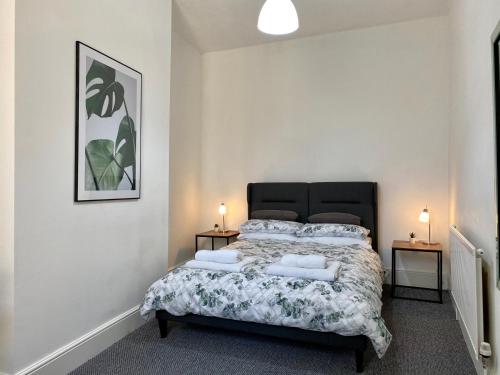 a bedroom with a large bed with two night stands at Be My Guest Liverpool in Liverpool