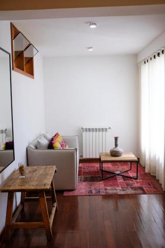 a living room with a couch and a table at Tocuyeros Boutique Hotel in Cusco