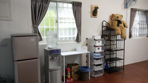 a room with a teddy bear sitting on a shelf at 光華民宿 in Chaozhou