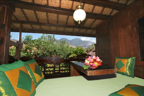 a room with a bed and a view of the mountains at Hotel Pondok Sari Beach & SPA Resort in Pemuteran