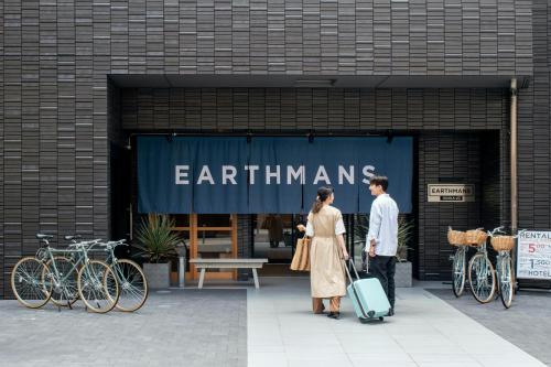 a man and woman standing in front of a store at EARTHMANS OSAKA-JO in Osaka
