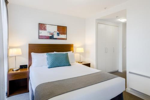 a hotel room with a bed and a desk at Quest on Dorcas in Melbourne
