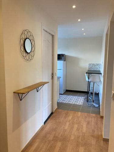 a hallway with a kitchen and a table in a room at Le Jeanne d'Arc - Appartements meublés in Gien