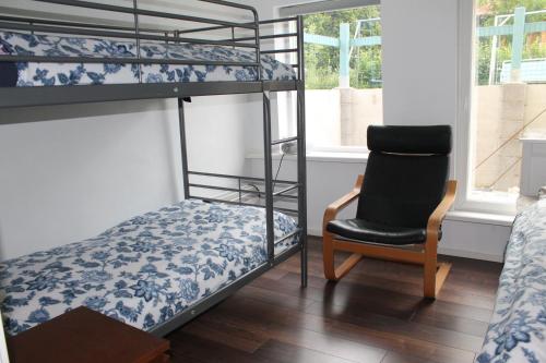 a bedroom with two bunk beds and a chair at Helsinki Hideaway in Helsinki