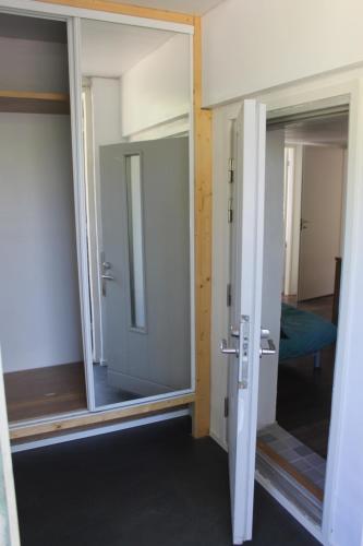 an open door with a mirror in a room at Helsinki Hideaway in Helsinki