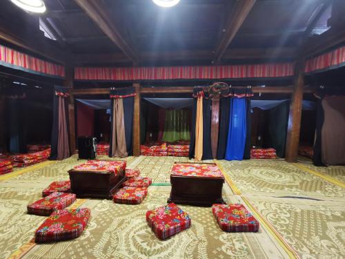 a room with four beds on the floor with curtains at Lo Lo Homestay & Cafe Meo Vac in Mèo Vạc