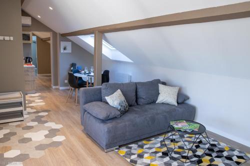 a living room with a couch and a table at Modern Living in Huningue
