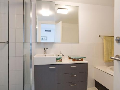 a bathroom with a sink and a shower at Lorne Chalet Apartment 10 in Lorne