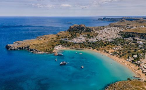 an aerial view of a beach with boats in the water at Lindos Calmare Suites in Líndos