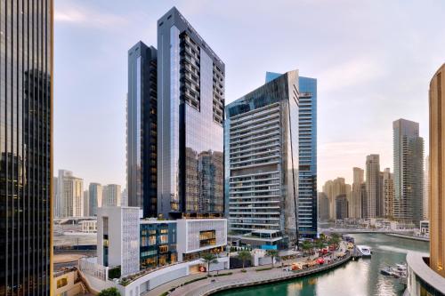 a city skyline with tall buildings and a river at Crowne Plaza Dubai Marina by IHG in Dubai