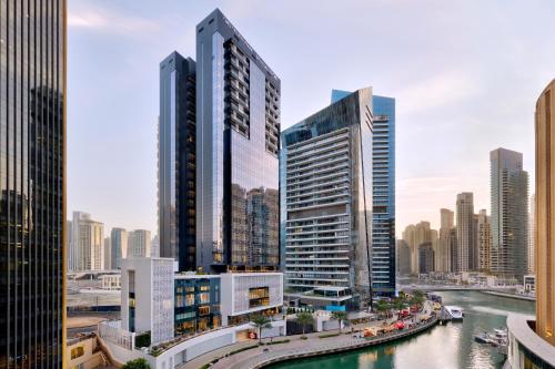 a city skyline with tall buildings and a river at Crowne Plaza Dubai Marina, an IHG Hotel in Dubai