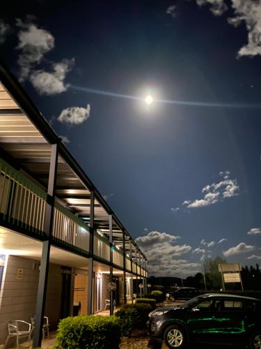 a car parked in front of a building at night at Snow Season Motor Inn in Cooma