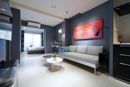 a living room with a couch and a table at Real Life Meguro River in Tokyo