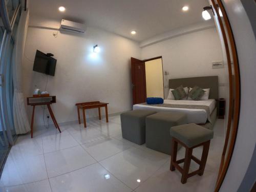 a bedroom with a bed and a mirror at Hill Country Villa in Kandy