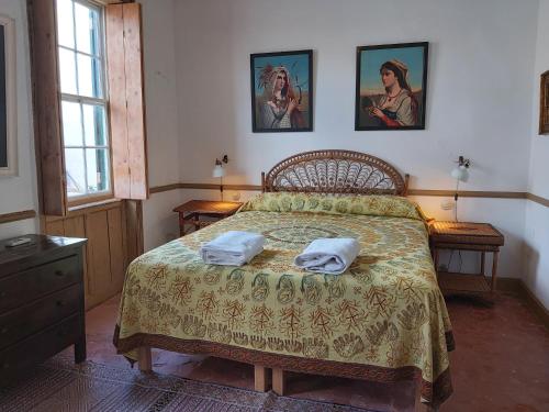 a bedroom with a bed with two towels on it at Sant Roc in Mahón