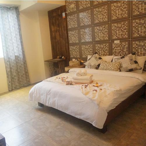 a bedroom with a large bed with towels on it at 馬公港精品旅宿包棟烤肉附設租車 in Magong