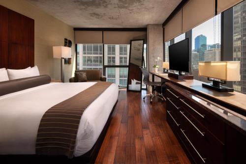 a hotel room with a large bed and a television at Eurostars Magnificent Mile in Chicago