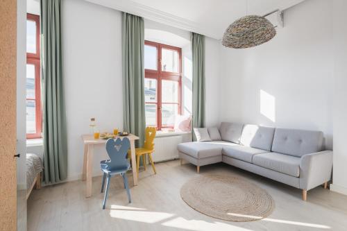 a living room with a couch and a table at Piotrkowska Welcome Apartments in Łódź