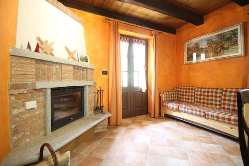 a living room with a couch and a fireplace at La terrazza in Ceresole Reale