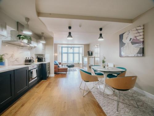 a kitchen and living room with a table and chairs at Bessemer House Sheffield City in Attercliffe