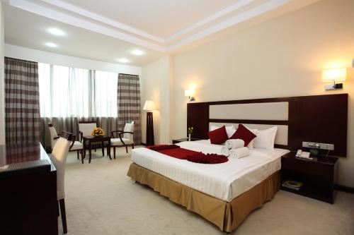 a hotel room with a bed and a dining room at Harmony Hotel in Addis Ababa