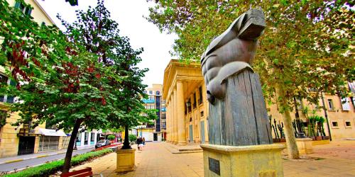 a statue of a bird on a pedestal in front of a building at ABAL Apartments - Barrio in Alicante