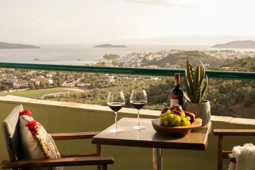a person sitting at a table with a bowl of fruit at Vigles Sea View, Philian Hotels and Resorts in Skiathos