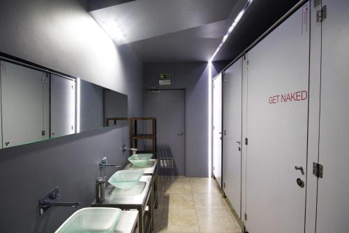 a bathroom with a sink and a toilet at PILOT Design Hostel & Bar in Porto