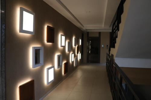 a hallway with a bunch of pictures on the wall at SK Lords Inn Ahmedabad in Ahmedabad