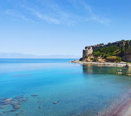 a view of a beach with a castle in the distance at Apartments Xenios Zeus 1 in Koroni